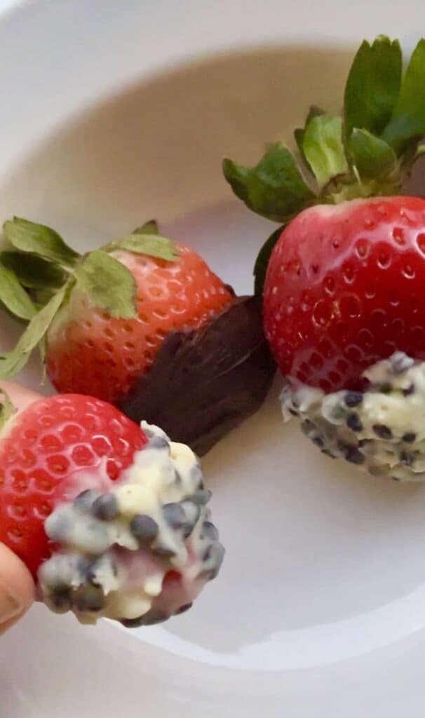 Close-up of fresh strawberries dipped in sugar-free dark chocolate and white cookies-and-cream chocolate.