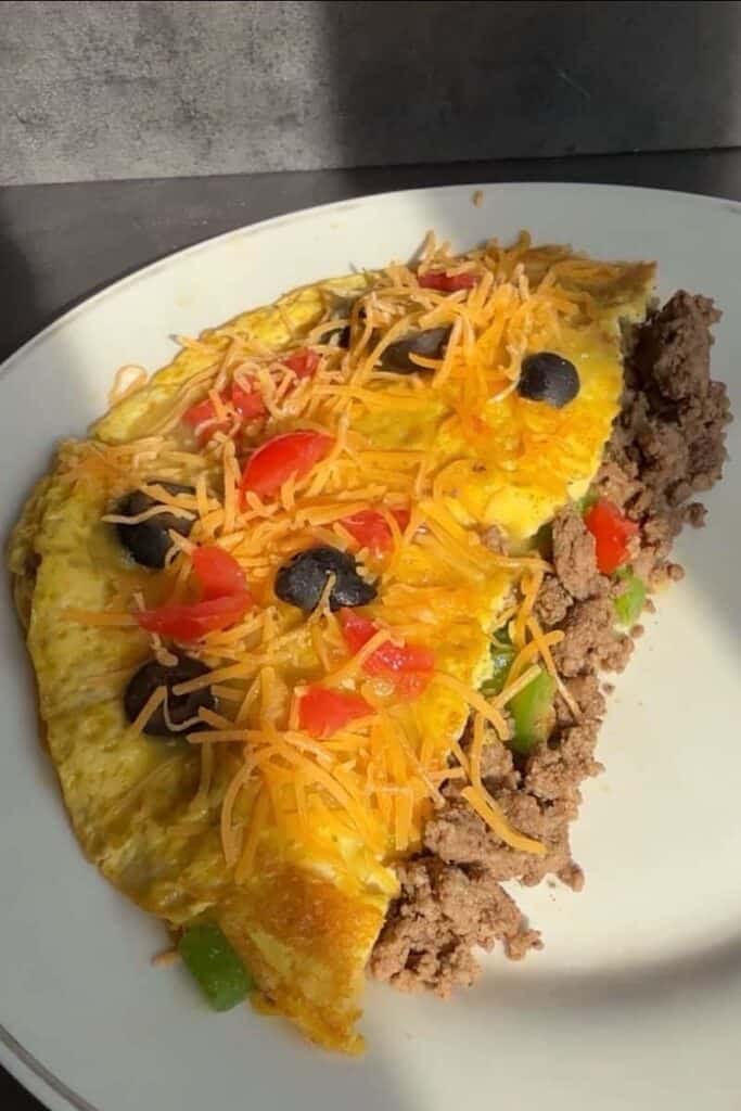 Taco night meets breakfast in this easy taco omelette recipe. Packed with protein from eggs and ground beef, this breakfast option is flavorful, filling, and simple enough for busy mornings or even a quick dinner.