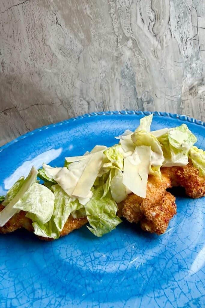 Breaded chicken cutlets cooking in the air fryer basket