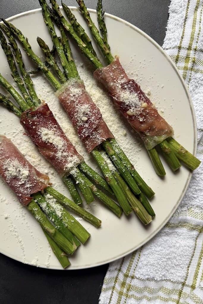 Asparagus spears wrapped in prosciutto with melted cheese inside