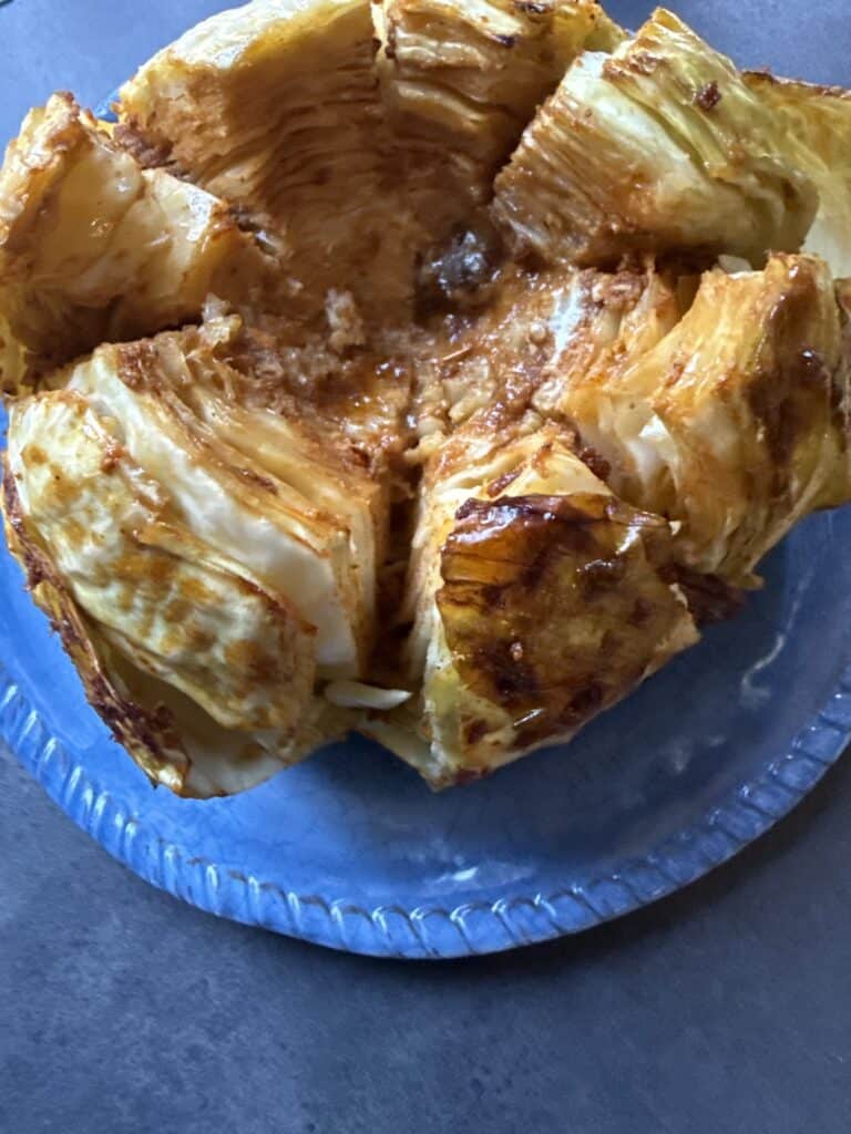 Diabetic-friendly viral cabbage boil recipe made with baked whole green cabbage, garlic butter, and Cajun seasoning.
