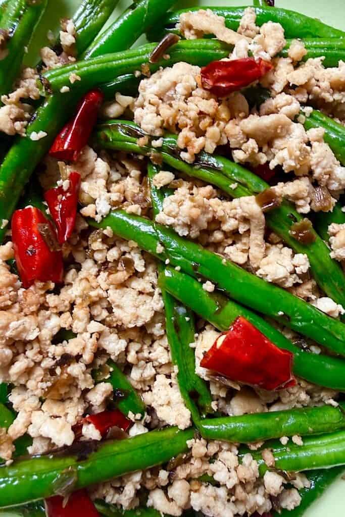Close-up of Szechuan green beans with ground pork, garlic and dried chilies